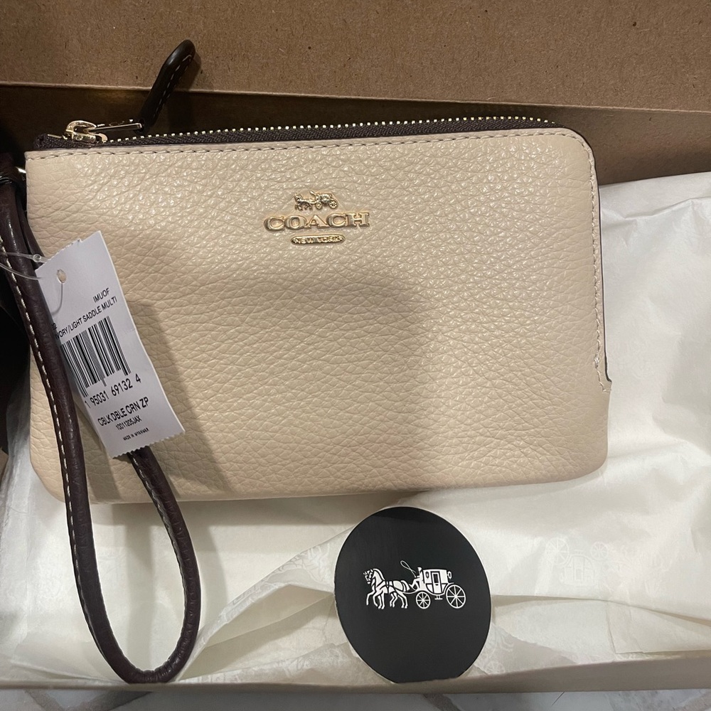 Coach double zip wristlet. Ivory and light saddle. Never used, tag attached